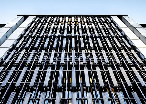 Facade of a modern building with repetitive vertical metal fins